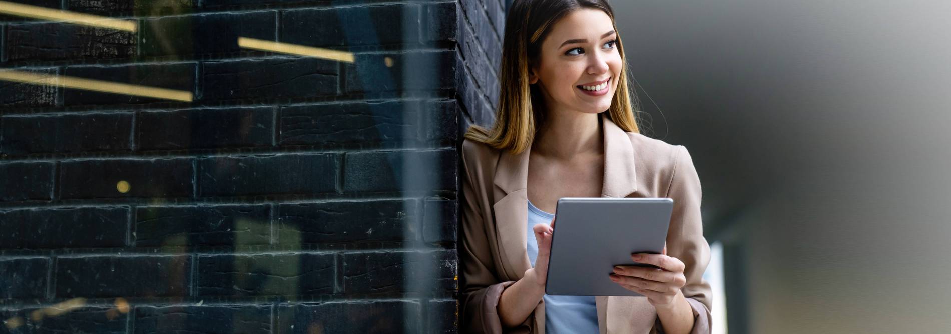 Woman happily checks her emails on the tablet