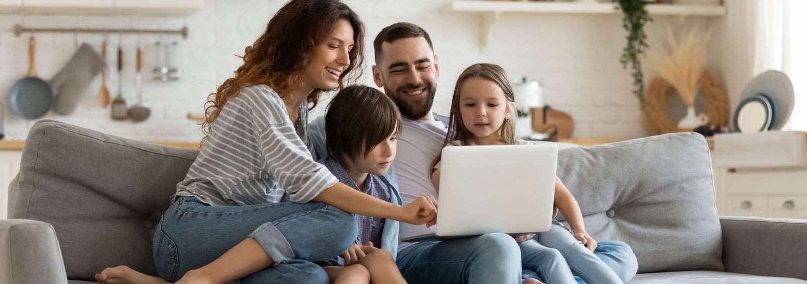 Family on sofa informs about the cheapest internet subscriptions