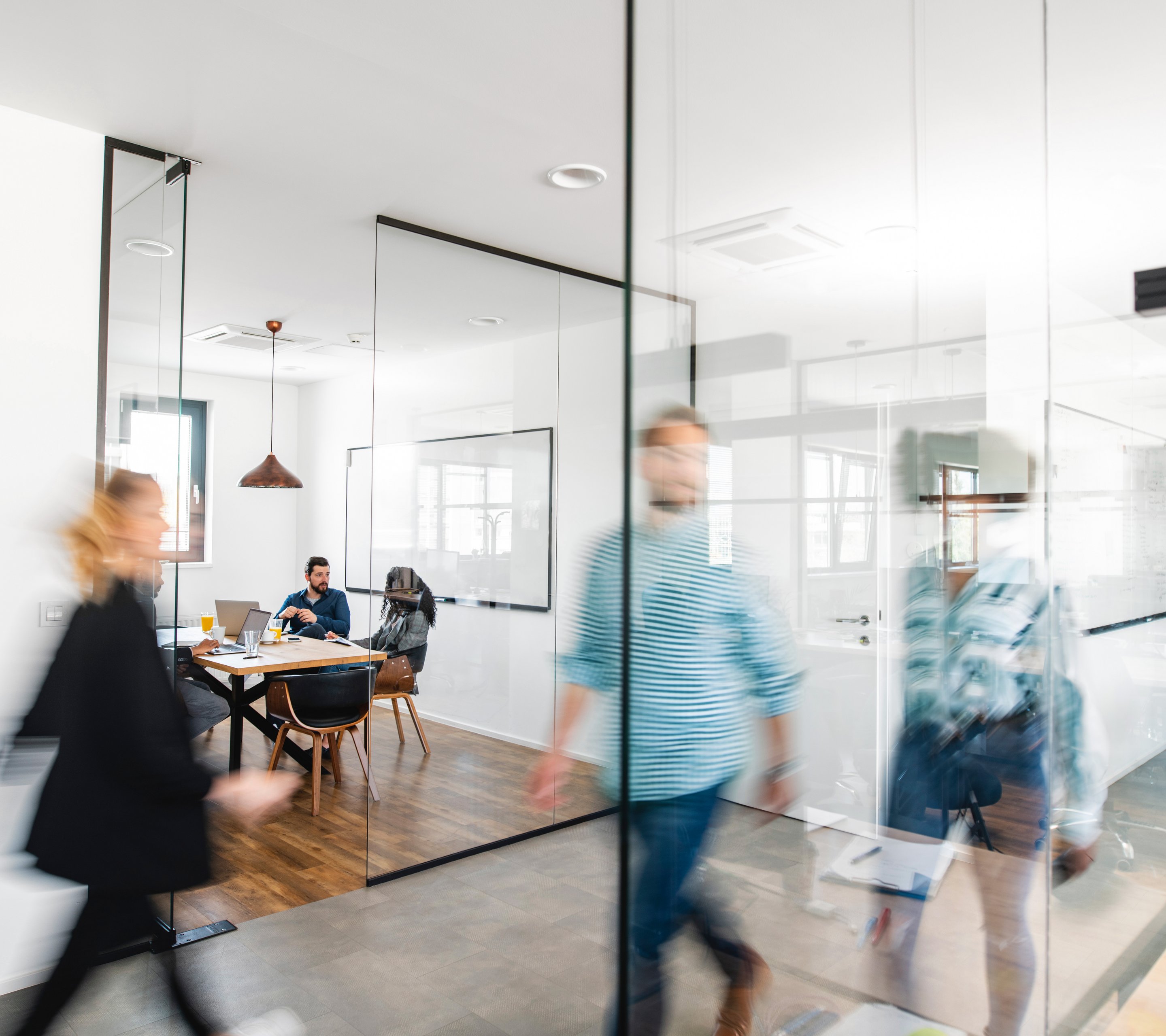 People are moving through an office