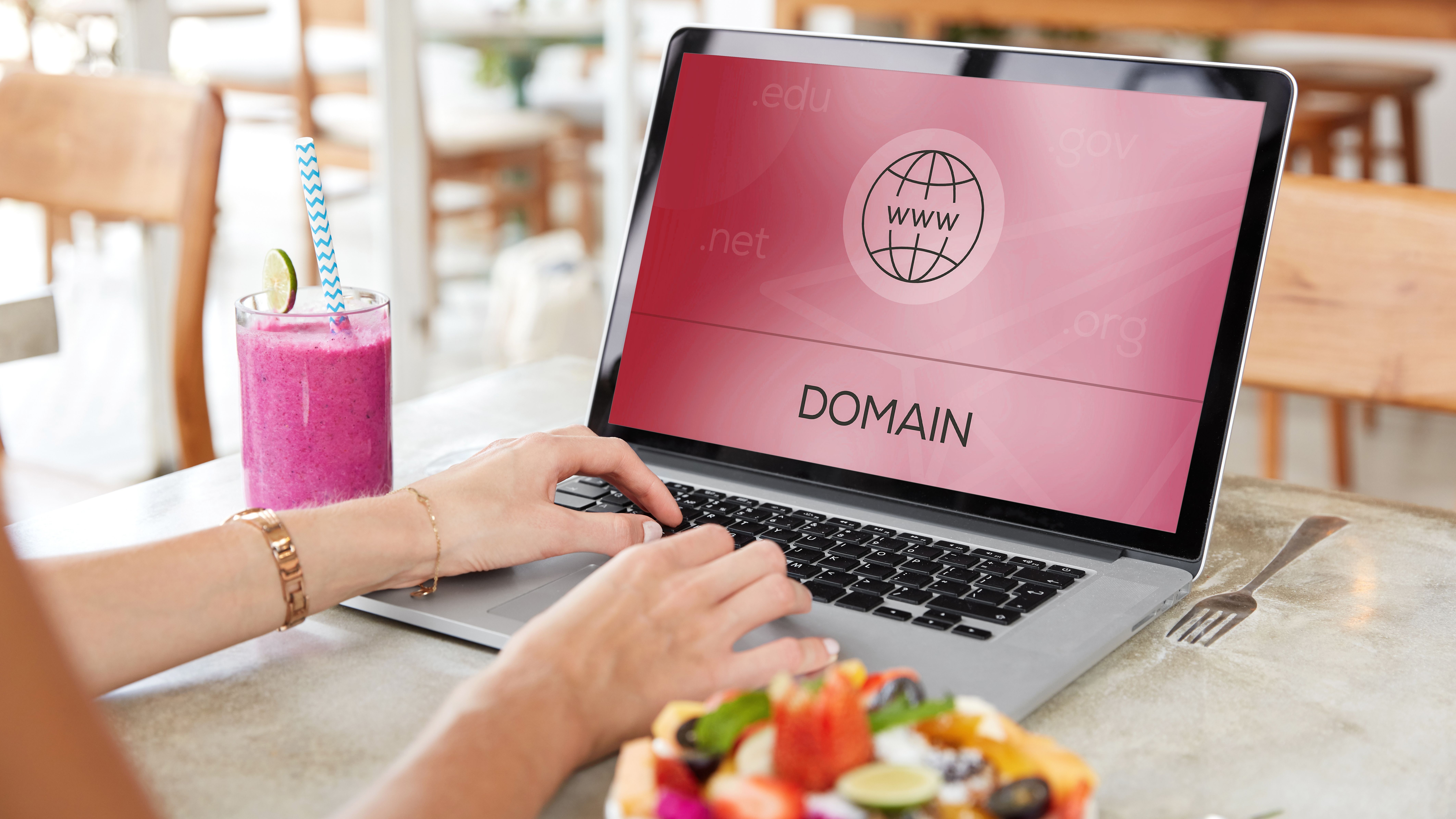 Woman looking for domain for website on laptop